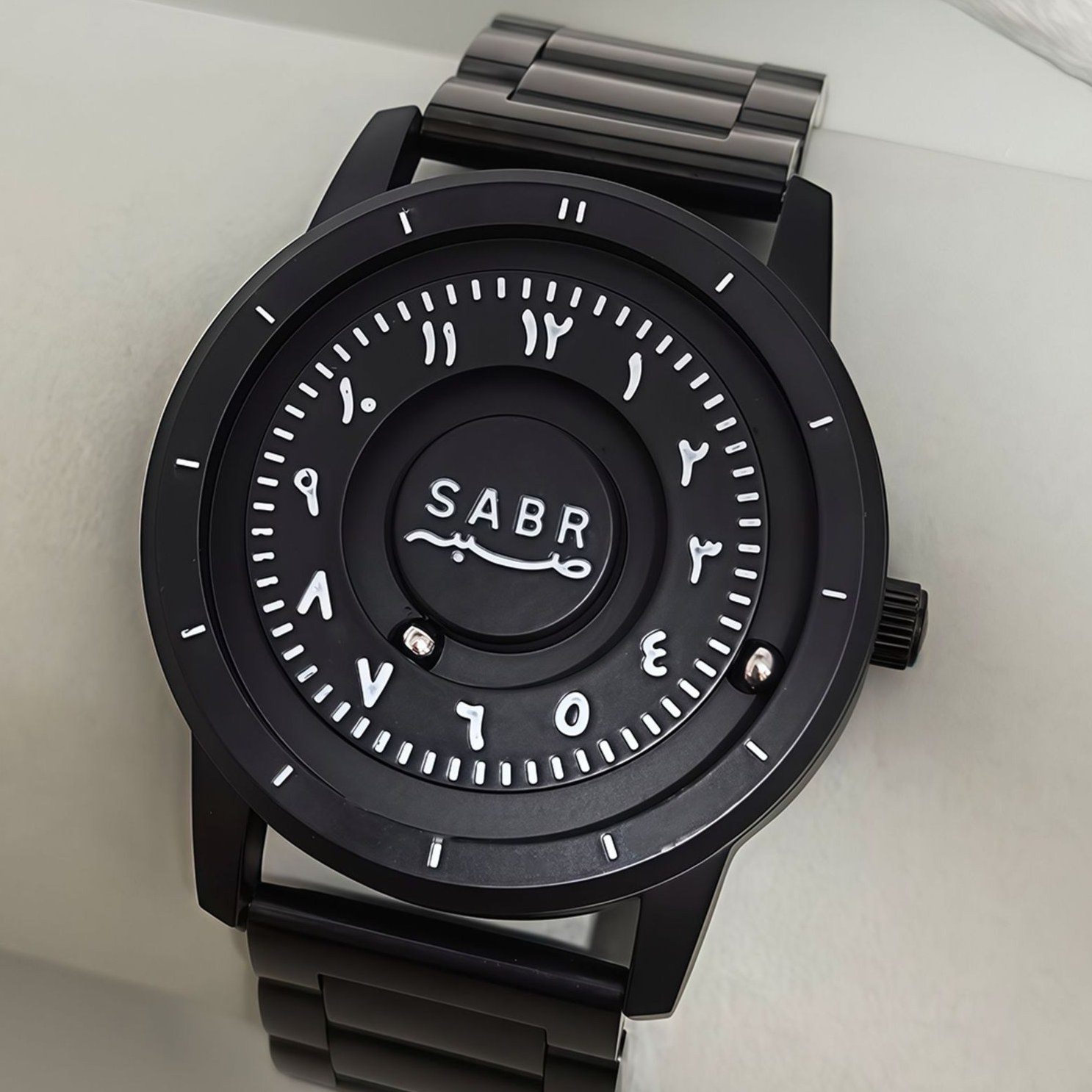 Sabr Watch by SmartMuslim, Islamic watch with black metal bracelet and Arabic numerals.