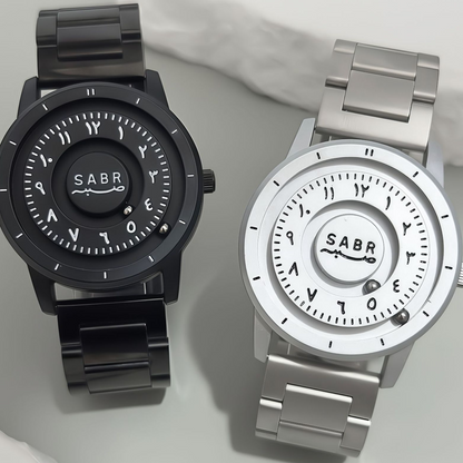 Sabr Watch pair: two Islamic watches in black and silver with metal link bands and circular Arabic numeral dials.