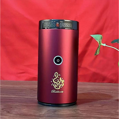 Bluetooth Bakhoor Burner, electric bakhoor incense burner by SmartMuslim, burgundy cylindrical unit with power button.