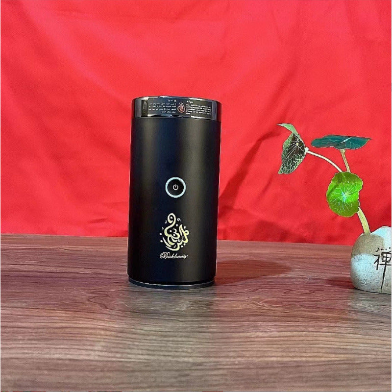 The Bluetooth Bakhoor Burner, black electric bakhoor incense burner with a circular power button.