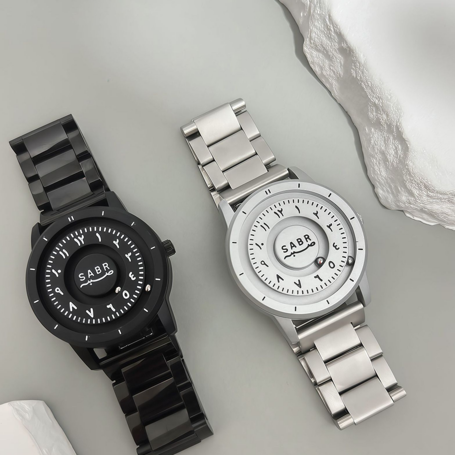 Sabr Watch by SmartMuslim; two metal Islamic watches in black and silver.