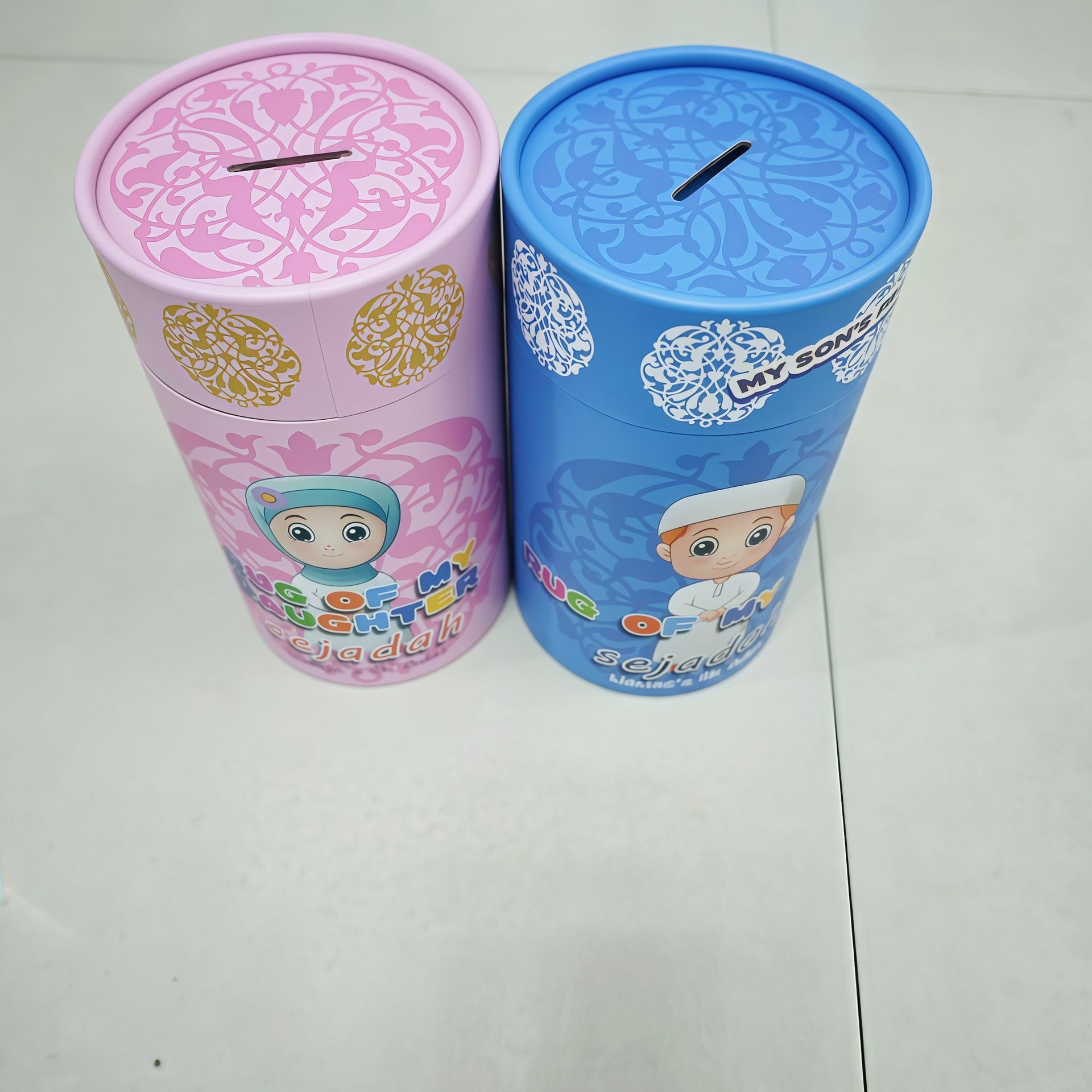 Little Muslim Starter Set: two pink and blue decorative canisters with ornate white patterns and child illustrations