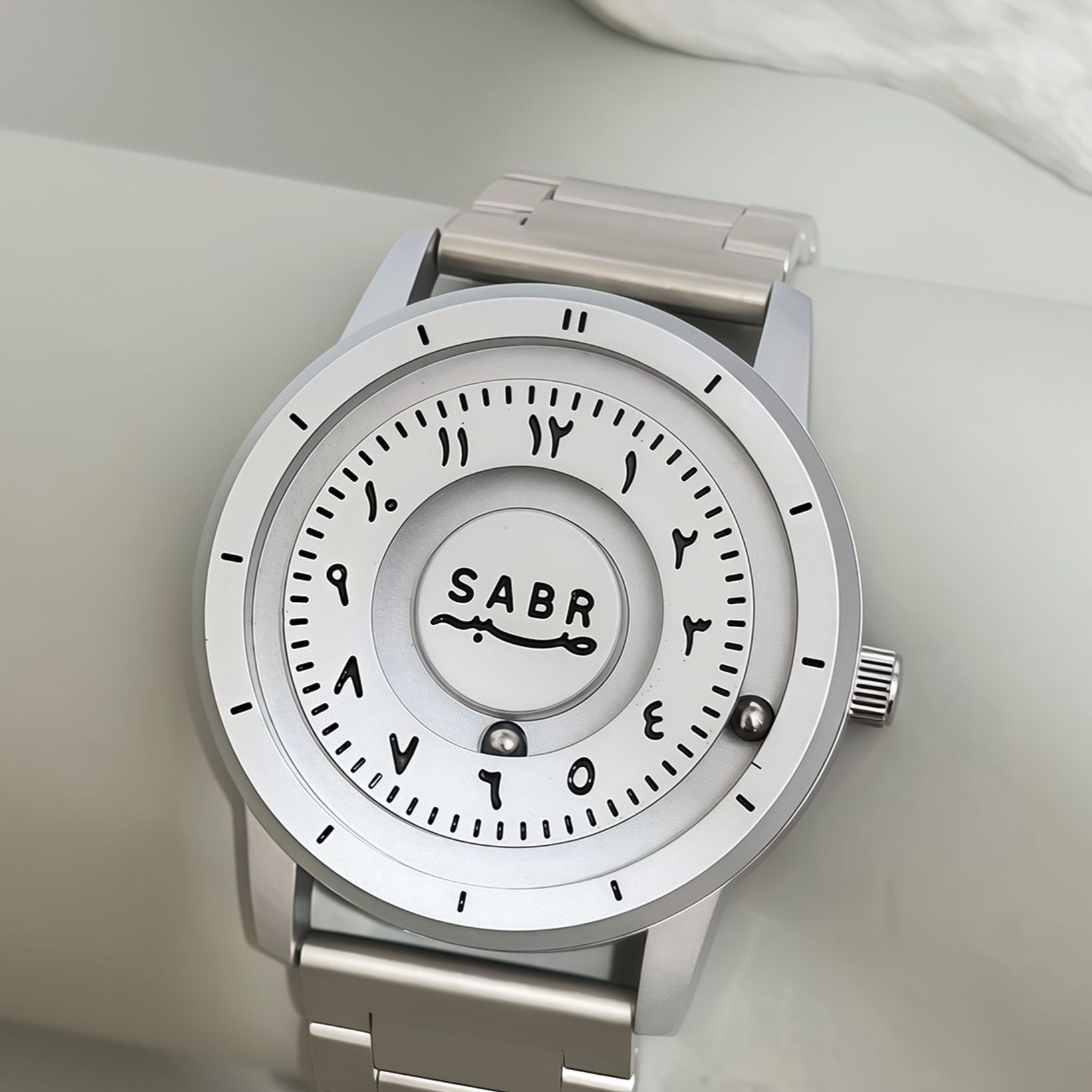 Sabr Watch, silver-toned stainless steel Islamic watch with white dial and SABR logo.